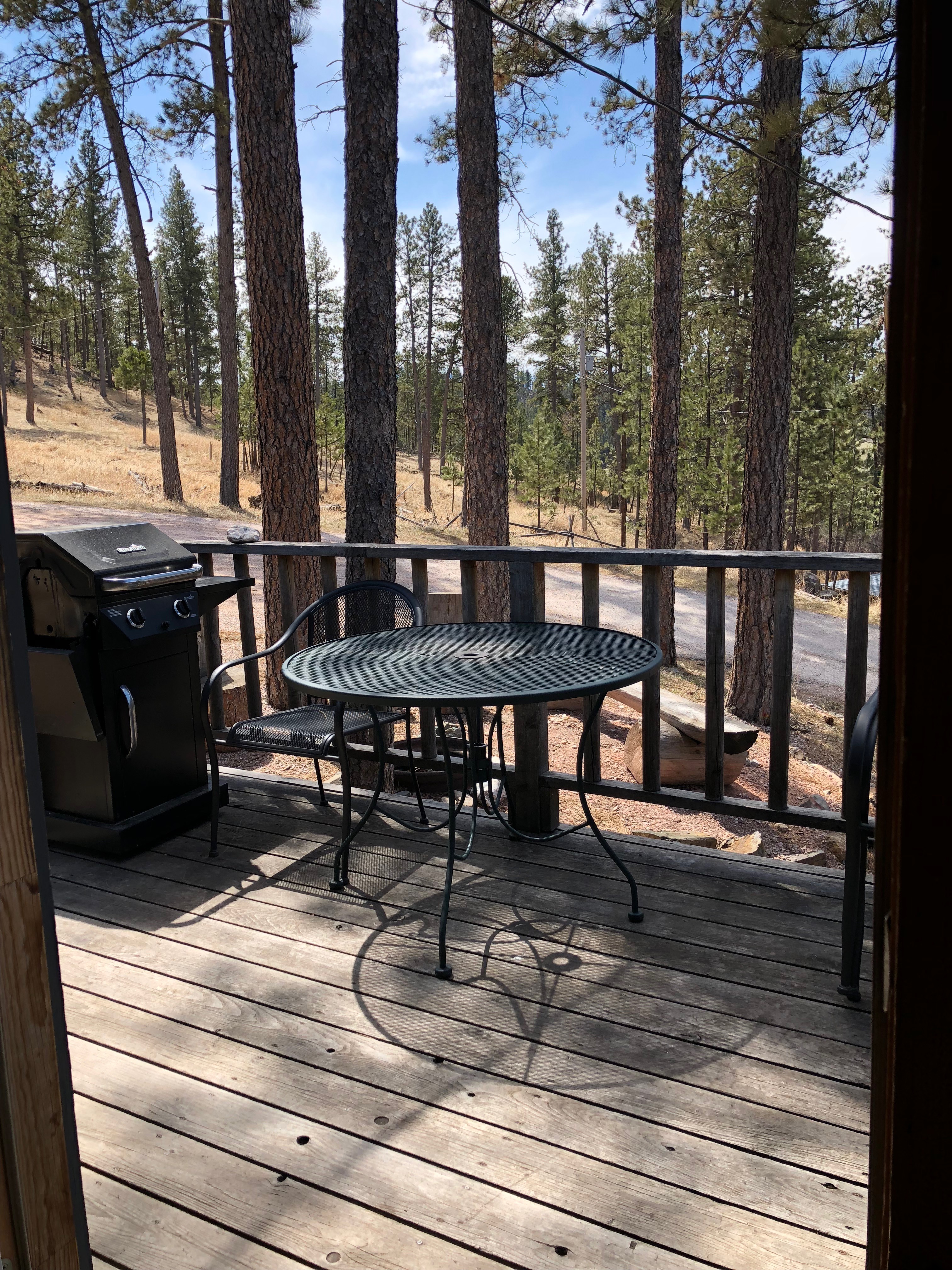 table and barbecue on a deck