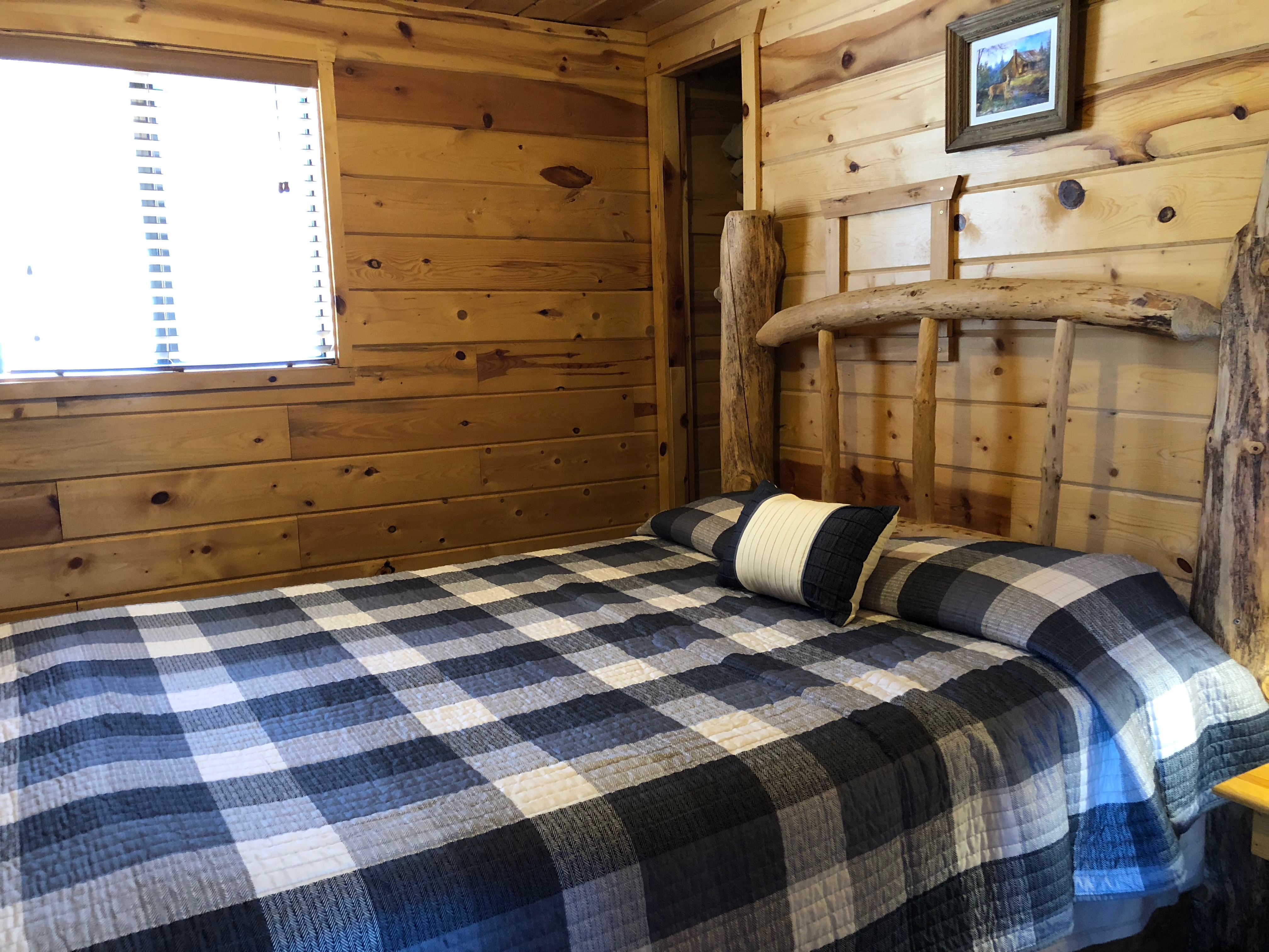 bed with blue and white checkered blanket