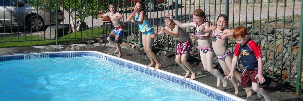 people jumping into a pool