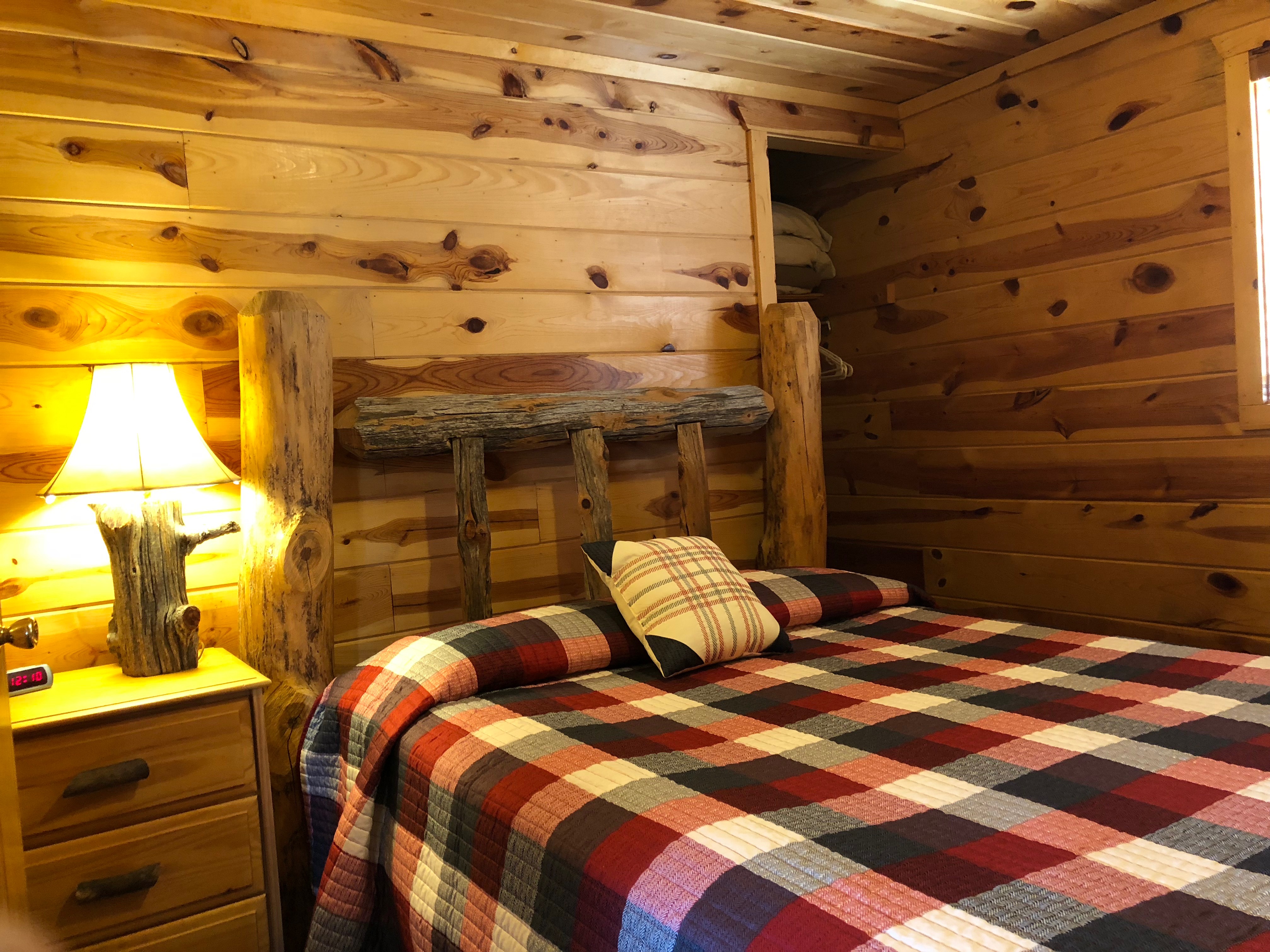 bed in room with checkered blanket